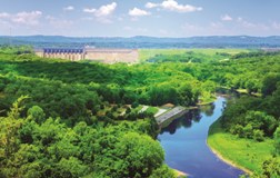Panoramic view of Lake Taneycomo and surrounding green hills with Table Rock Dam in the distance