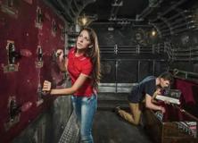 Guests interacting with hands-on exhibits inside an escape room
