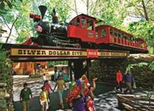 Historic steam train crossing above park guests at Silver Dollar City