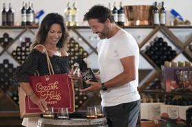 �Couple browsing wine selections inside a local tasting room, representing relaxed experiences found among Branson Museum and Attractions.�