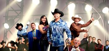 Large ensemble of performers on stage wearing western attire during an energetic live music and entertainment show.