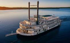 Classic Branson riverboat cruising at sunset, a signature experience often included in a Branson vacation package with transportation