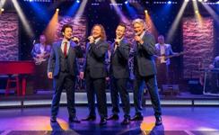 Vocal quartet performing live on a Branson theater stage, a popular show featured in a Branson vacation package with transportation