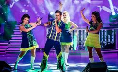 Energetic live stage performance by Branson entertainers, commonly featured in a Branson vacation package with transportation for convenient show and attraction access.