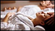 Couple receiving side-by-side spa massages in a calm setting during a Romantic stay in Branson.