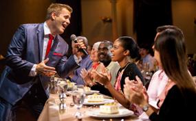 Dinner show in Branson with a performer engaging guests tableside, creating a lively, memorable evening entertainment experience