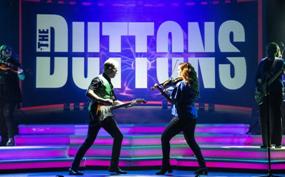 High-energy live performance on a Branson stage with professional lighting and a cheering audience, highlighting entertainment stops commonly included in Branson bus tour packages, including seasonal favorites like Branson Christmas bus tour packages and full-service Motor coach tour Branson MO itineraries.