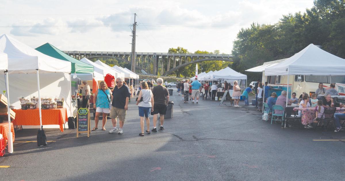 Outdoor community market with vendor tents, local shoppers, and handmade goods, showcasing budget friendly Branson MO activities and relaxed Branson vacation ideas for visitors.