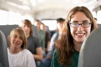 teenagers (14-16) riding school bus (focus on girl in foreground) - high school students on bus stock pictures, royalty-free photos & images